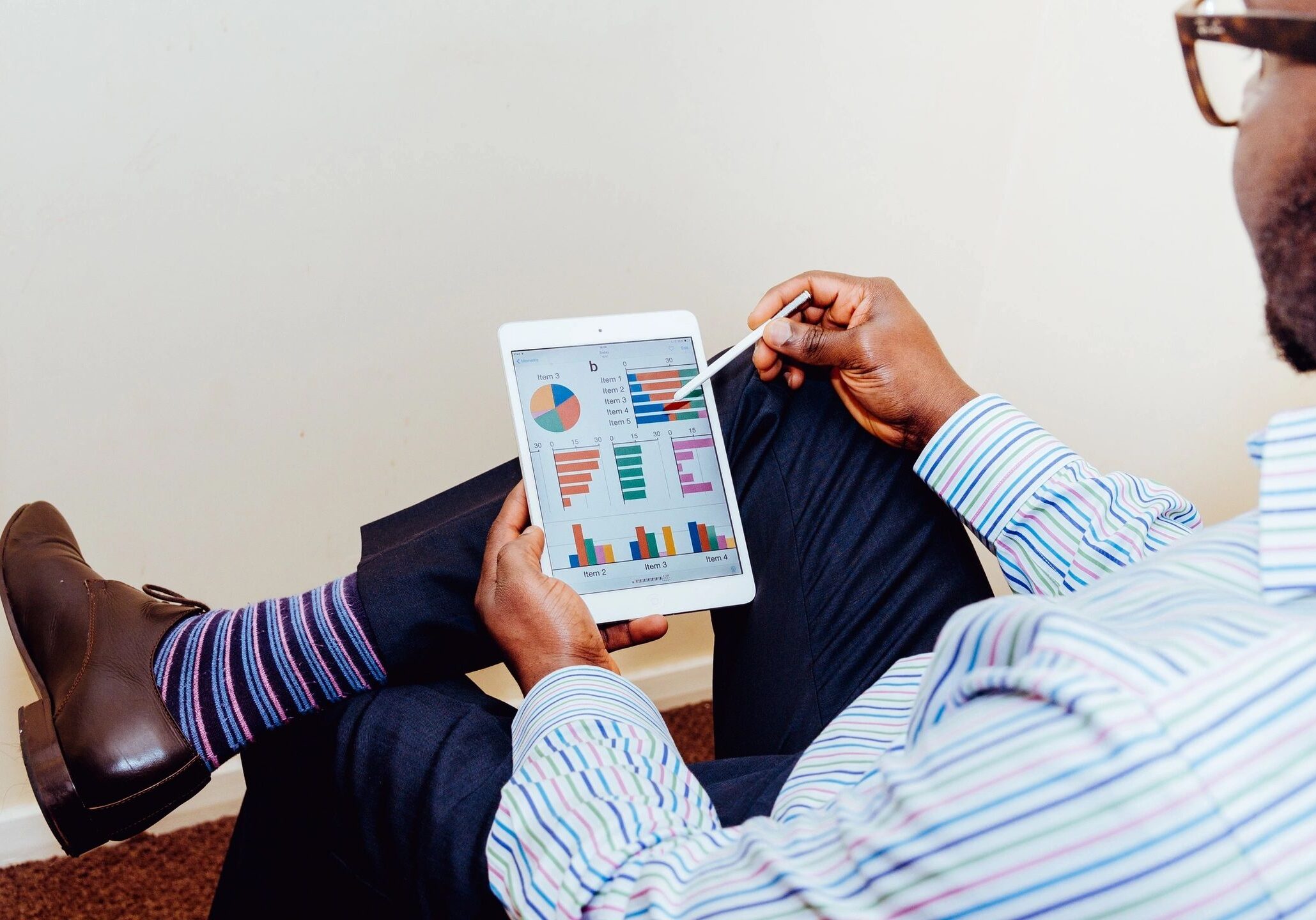 Man analyzing charts on a tablet.