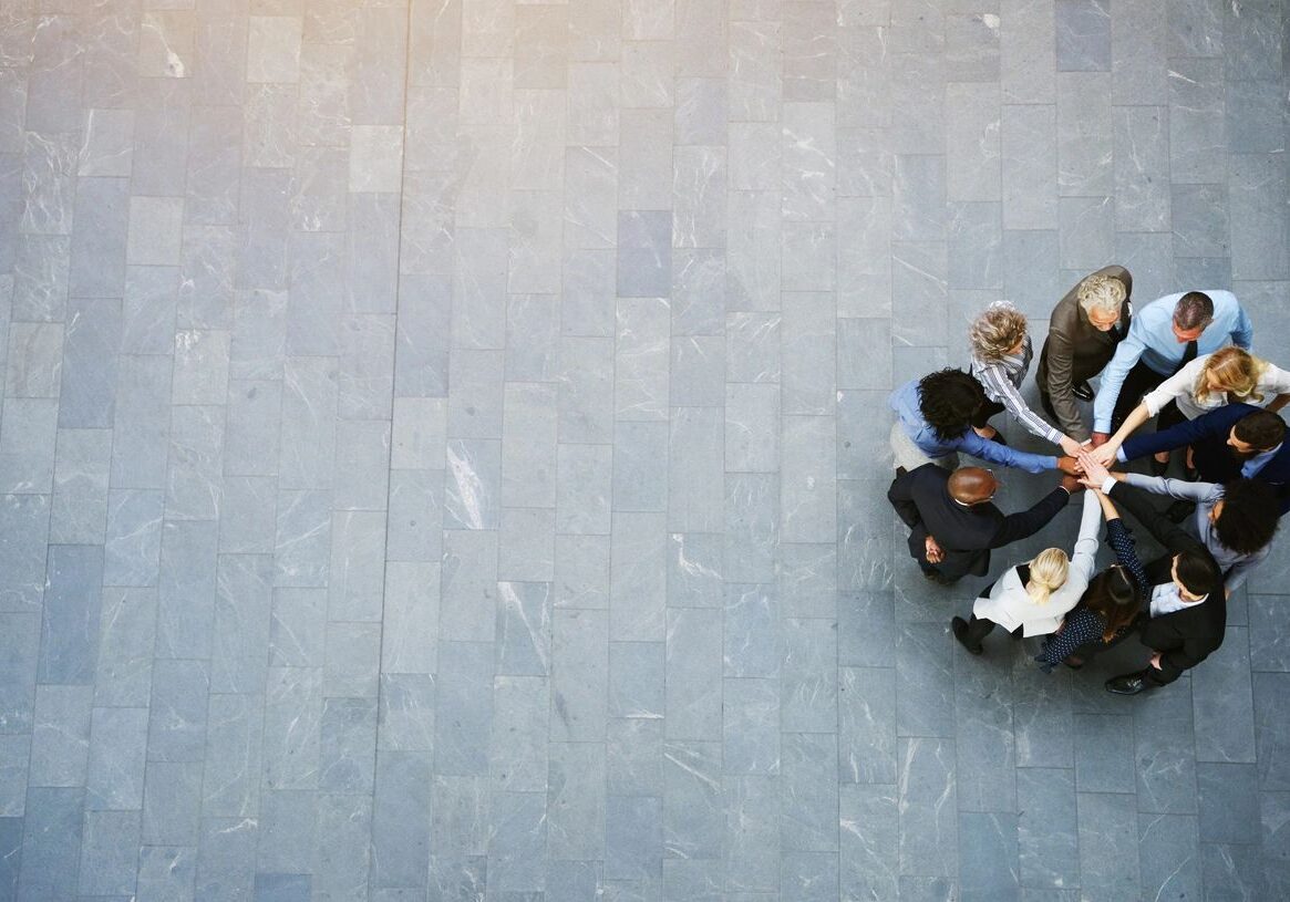 Team huddling together in a circle.